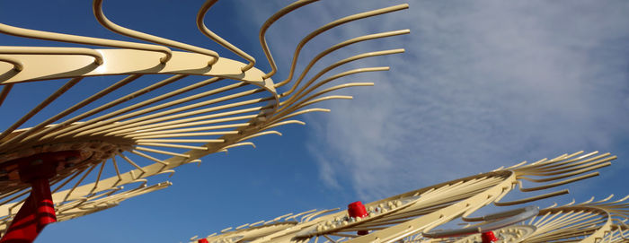 Low angle view of umbrellas hanging against building