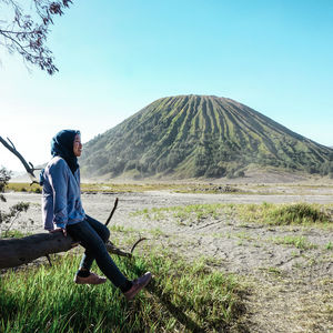 Full length of man standing on mountain against sky