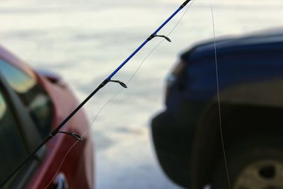 Close-up of fishing rod in sea