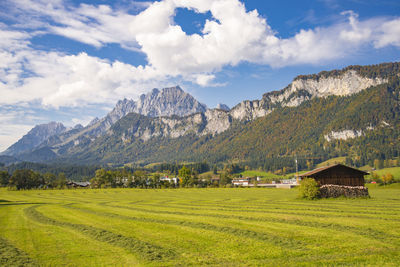 Scenic view of field and mountains against sky