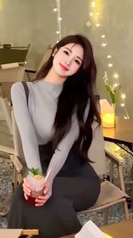 Portrait of young woman sitting at home