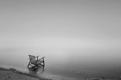 Stunning black and white seascape view with alone chair