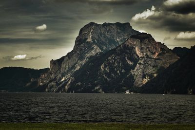 Scenic view of sea and mountains against sky