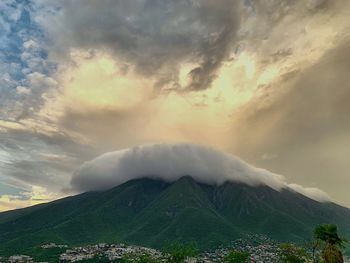 Scenic view of mountains against cloudy sky