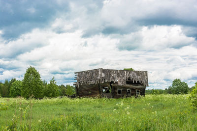 Abandoned building on field against sky