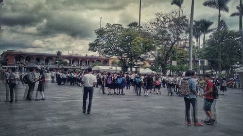 People walking on street against buildings