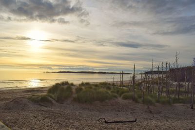 Scenic view of beach against sky during sunset