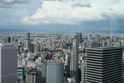 Aerial view of modern buildings in city against sky