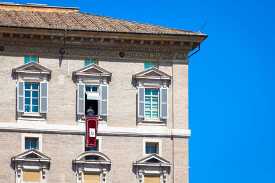 Low angle view of building against blue sky