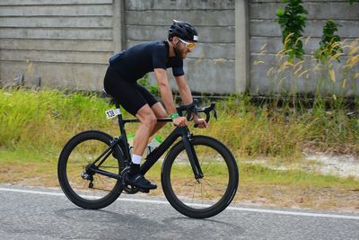 Man riding bicycle on road