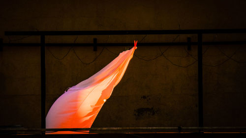Low angle view of flags against wall at night