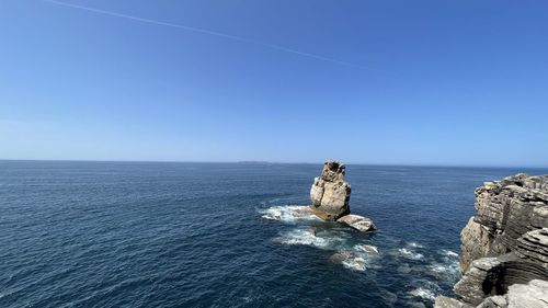 Scenic view of sea against blue sky