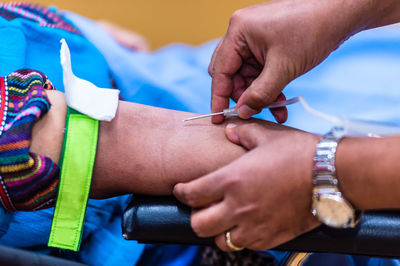 Close-up of doctor injecting syringe to patient