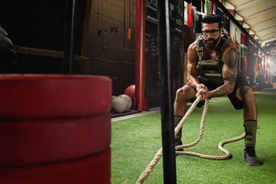 Low section of man exercising on field