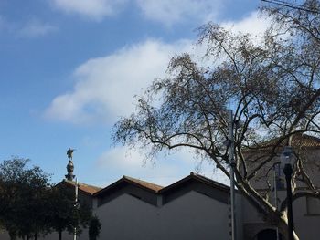 Low angle view of building against cloudy sky