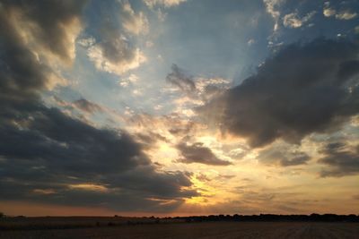 Scenic view of dramatic sky over land