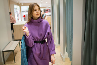 Young woman standing at home