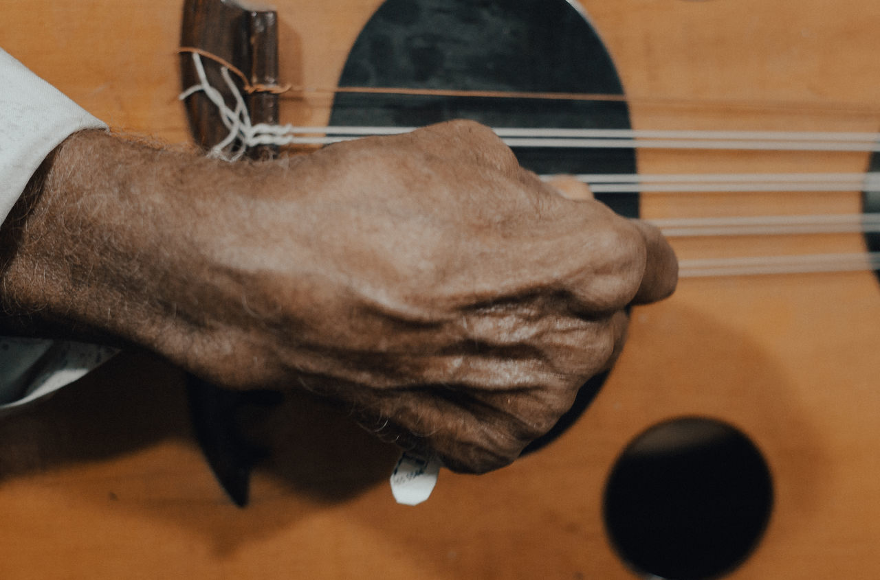 CLOSE-UP OF HAND ON TABLE AT HOME