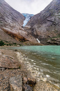 Scenic view of lake and mountains against sky