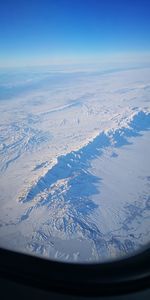 Aerial view of snowcapped mountains against sky
