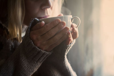 Close-up of woman drinking tea