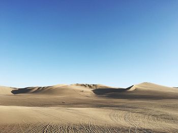 Scenic view of desert against clear sky