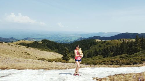 Woman on mountain against sky