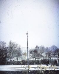 Snow covered landscape against sky