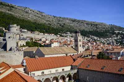 High angle view of buildings in town against sky