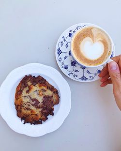 High angle view of cappuccino served on table