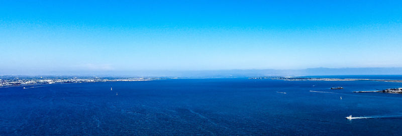 Scenic view of sea against clear blue sky