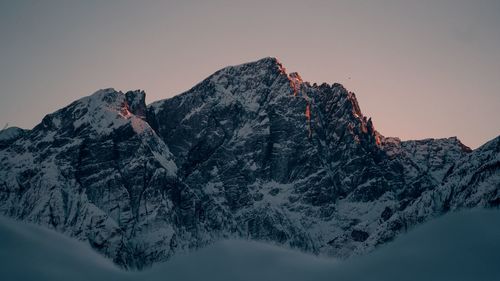 Snowcapped mountains against clear sky during winter