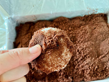 Cropped hand of person holding food