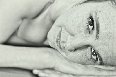 Close-up portrait of woman relaxing on bed