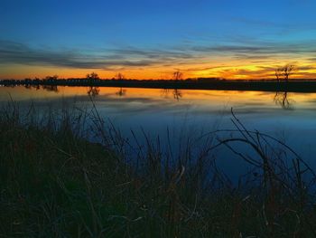Scenic view of lake against sky during sunset