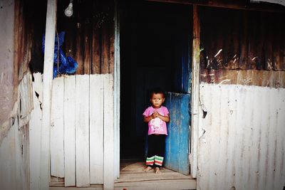 Girl standing against wall