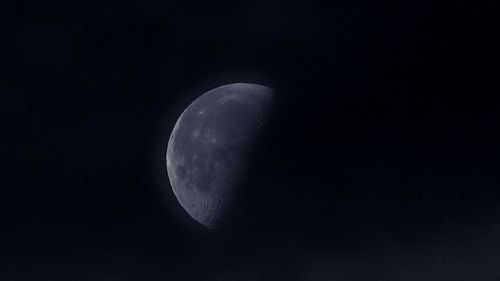 Low angle view of moon in the dark