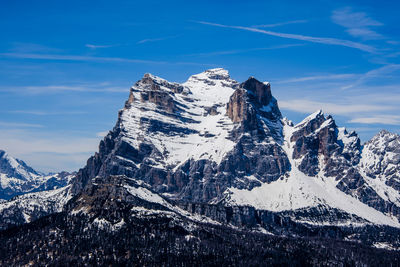 Scenic view of snowcapped mountains against blue sky