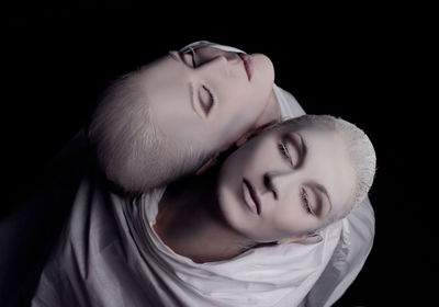 Directly above shot of women with make-up against black background