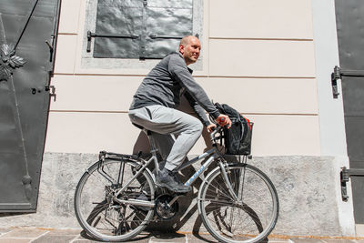 Portrait of a handsome hipster man. a man in a big city cycling down the street on a bicycle