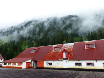 Red roof building next to mountain