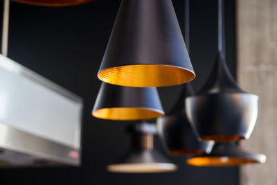 Close-up of illuminated electric lamp at home