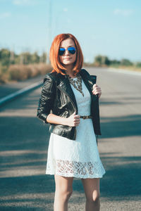 Portrait of woman wearing sunglasses standing outdoors