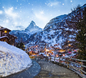 Scenic view of snowcapped mountains against sky at night