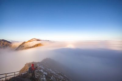 Man standing on mountain against sky