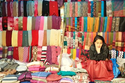 Portrait of smiling woman sitting at market