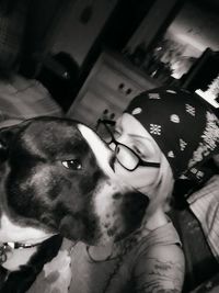 Portrait of woman holding dog at home