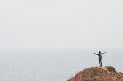 Rear view of man standing on beach