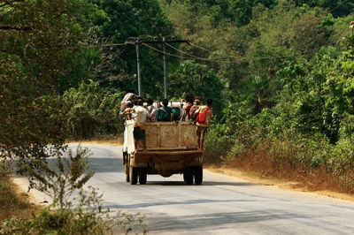 Rear view of people standing on truck