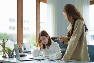 Business colleagues talking at office